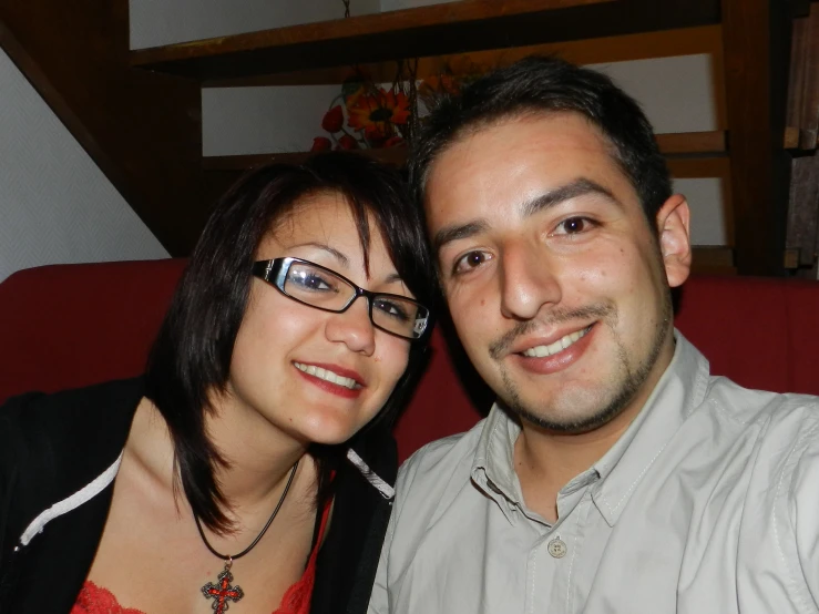 a woman with eye glasses standing next to a man
