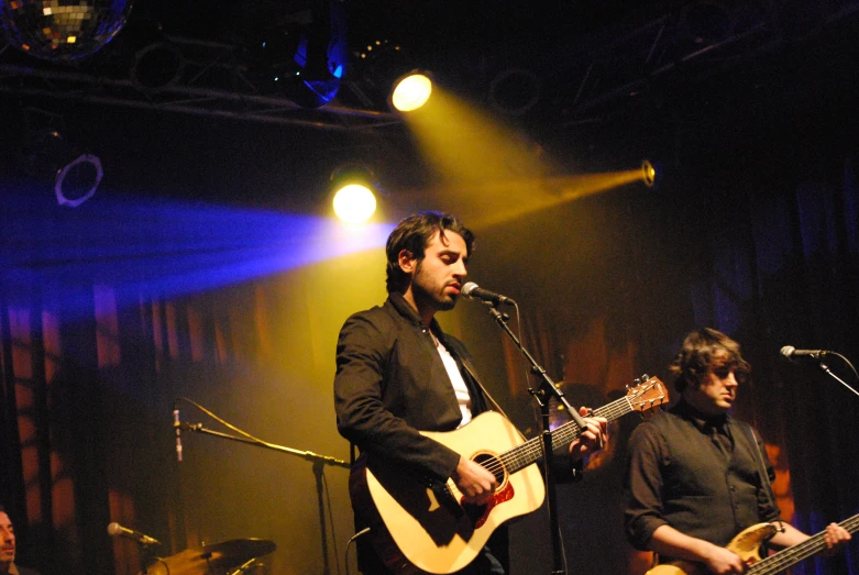 some men on a stage playing and singing