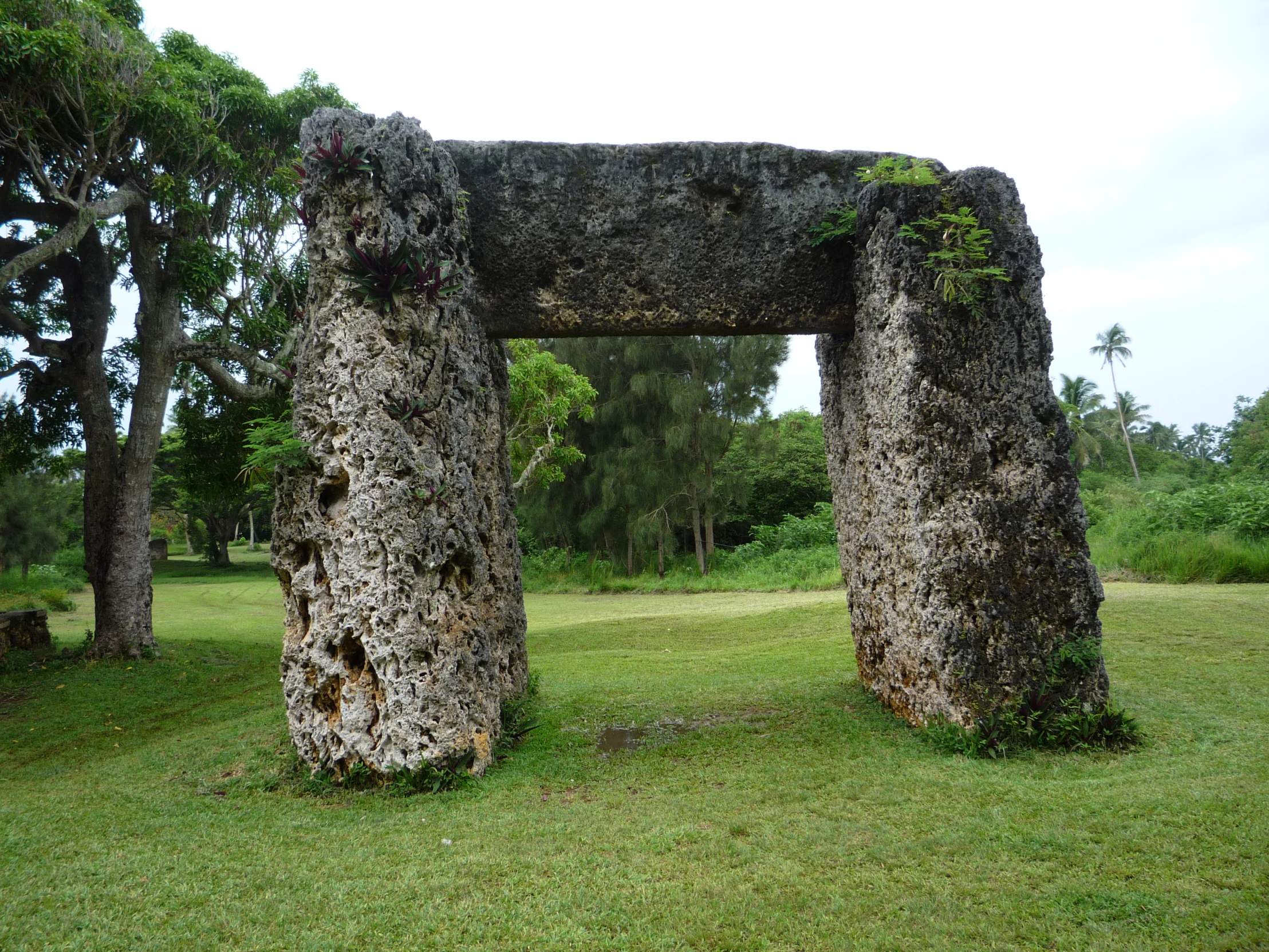 a couple of stone structures sitting in the middle of a field