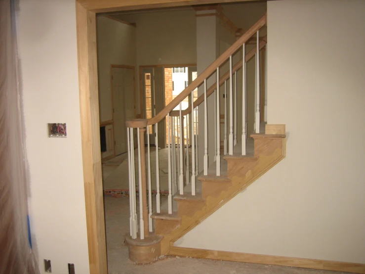 the entrance area of a new home with an open balcony and stairs