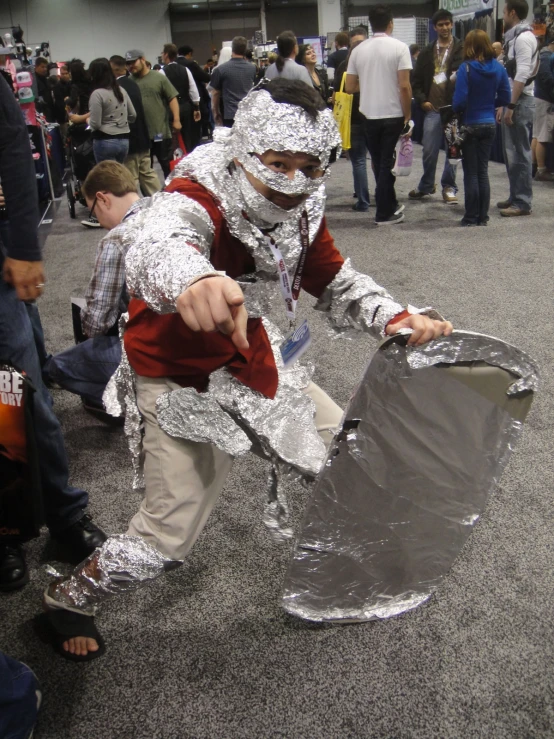 a person in foil with a suitcase on the floor
