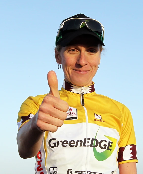 a woman giving a thumbs up with her bike jersey on