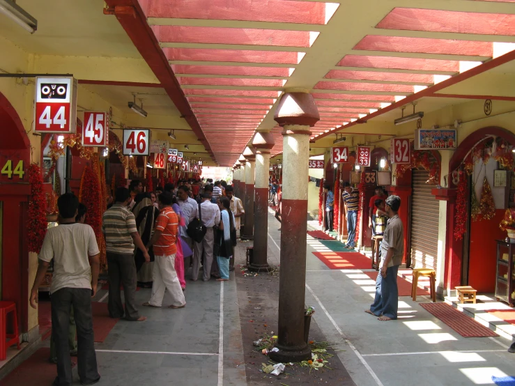 people are standing in line inside an asian market