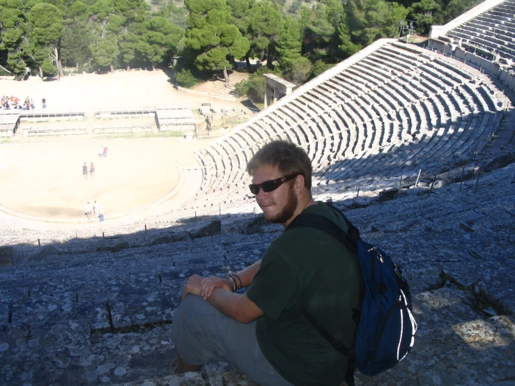 the man is sitting at the ampuleta