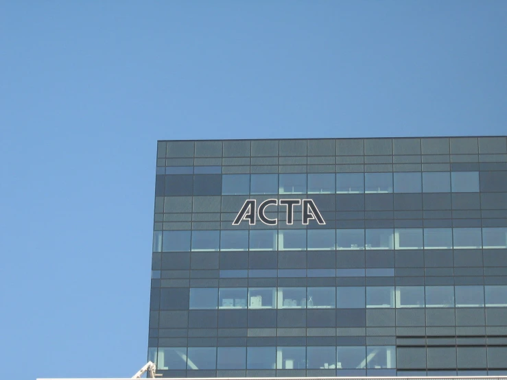 a tall building with a sign and a bird on top of it