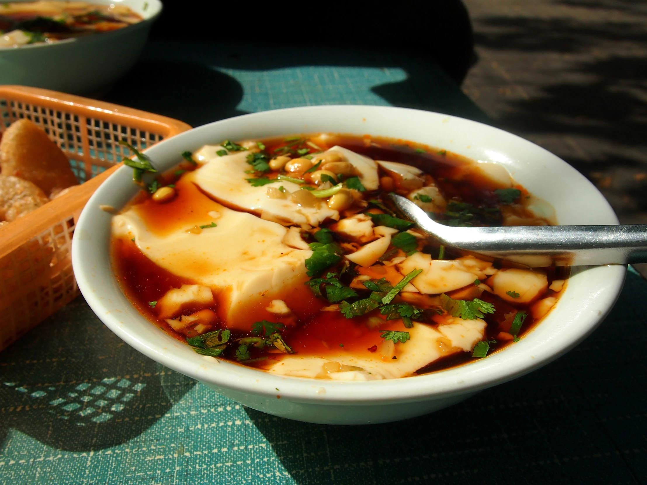 this is a bowl full of soup that has fish