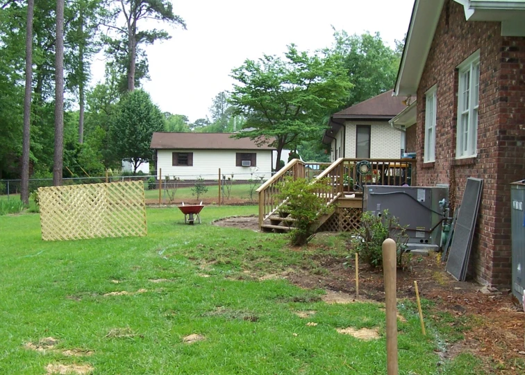 this backyard has two bushes in it and a lawn