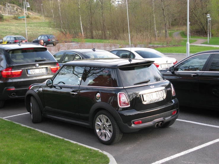 an all black mini cooper in a parking lot