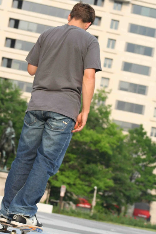 a young man riding a skateboard on a city street