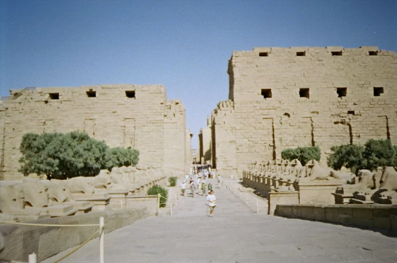 a person is walking down the sidewalk in front of some buildings