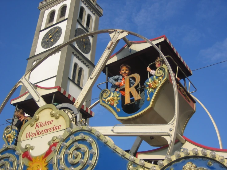 an old fashioned fairground ferris wheel and clock