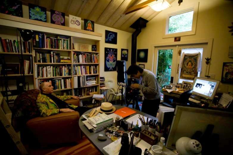 a man that is sitting in a chair in a room