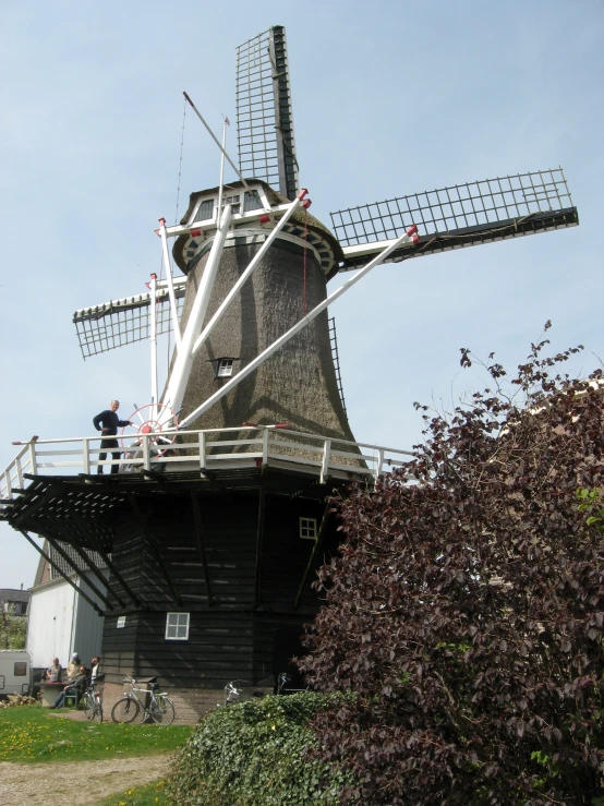 a man standing on the top of a tower of a windmill
