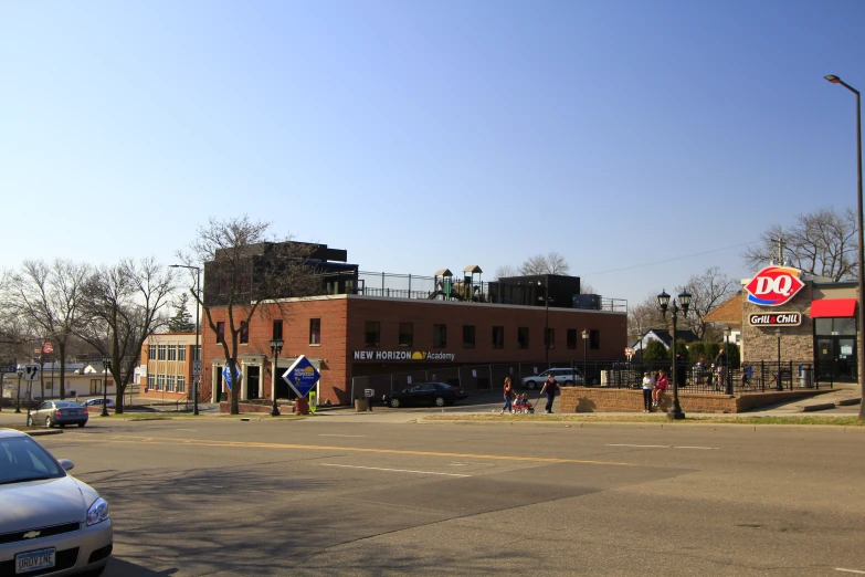 several cars parked on the street near a building