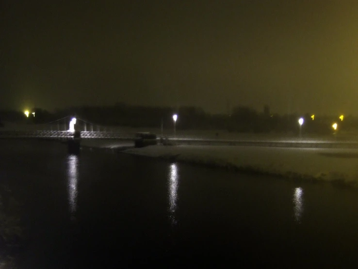 an image of some water and lights at night