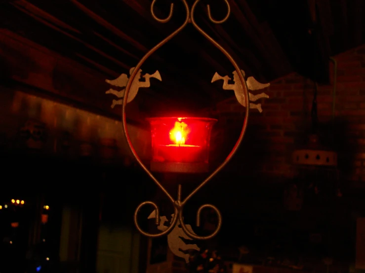 there is a small candle inside of the red light