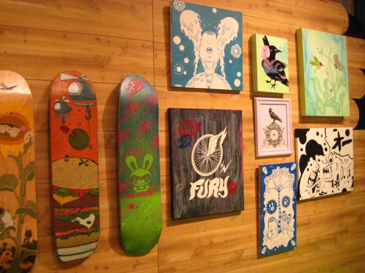 five different colored skateboards mounted to the wall