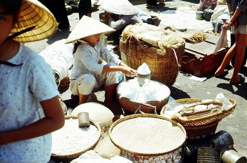 many baskets, including two women with hats, are on display