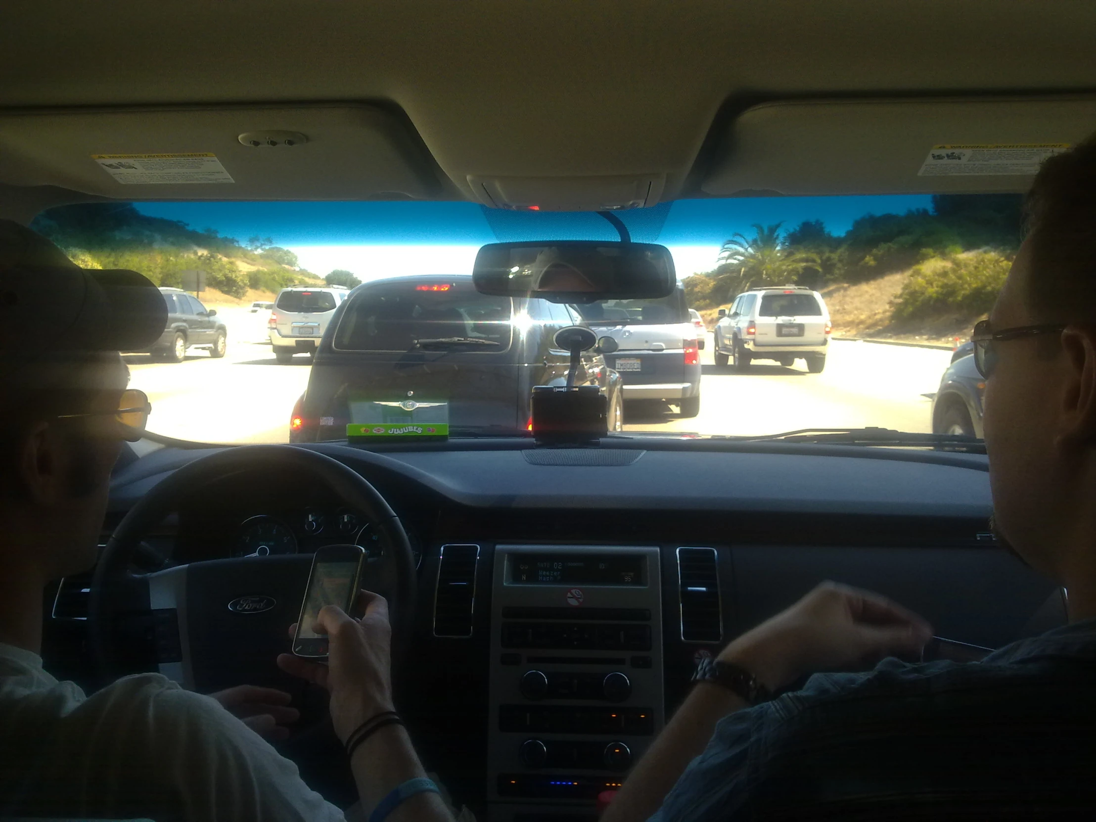 a view of a group of cars from a vehicle's dash