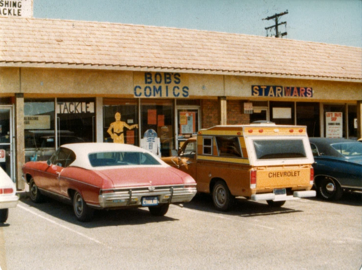 cars are parked outside of a star arts shop