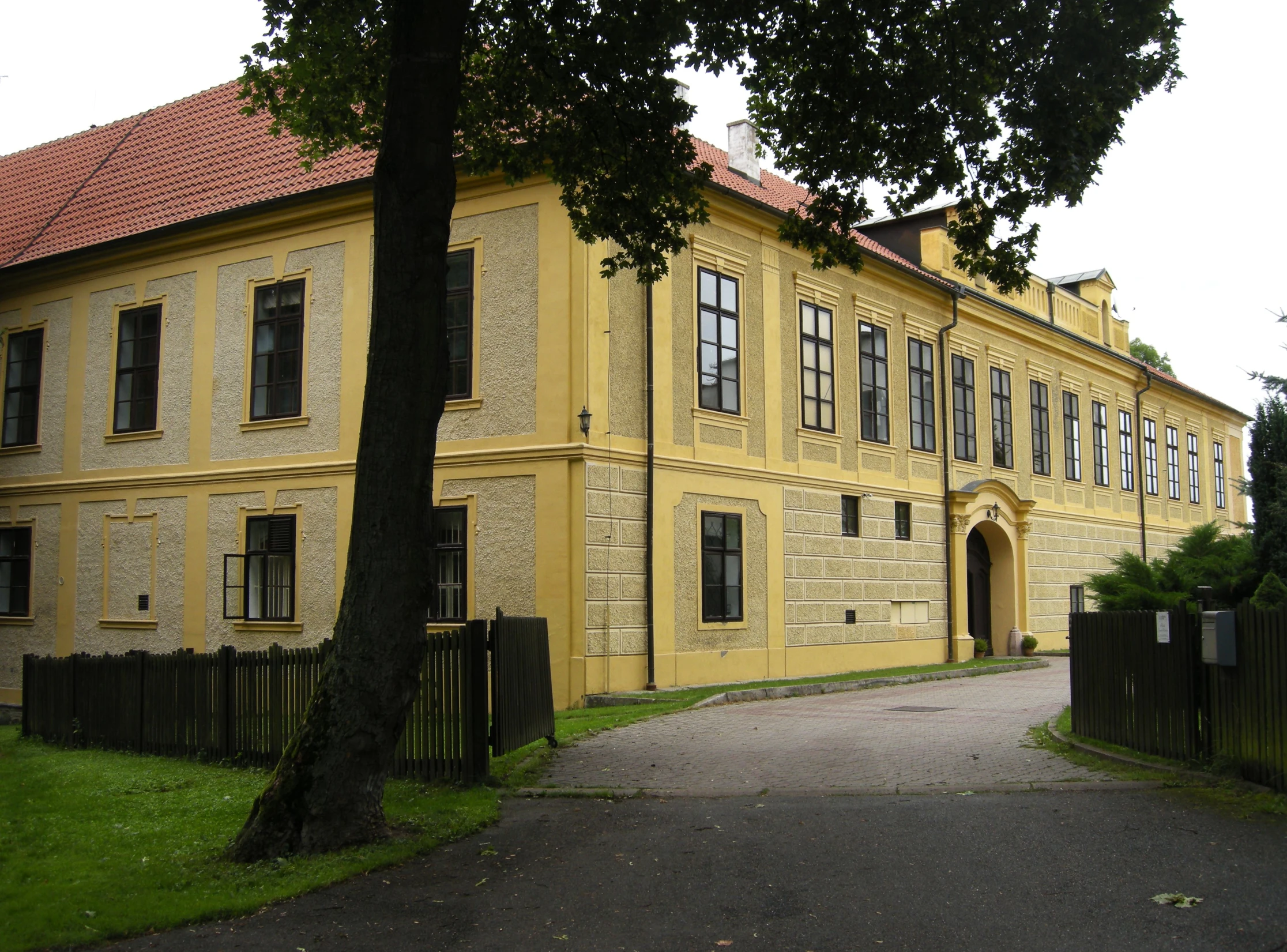 there is a yellow building on the side of the road