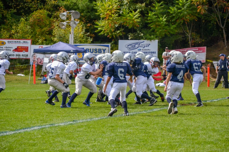young football players running onto the field