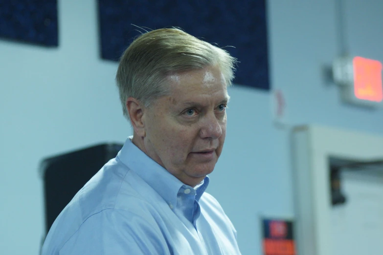 a man in a dress shirt and tie at a basketball game