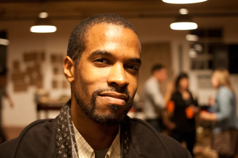 a close up view of a man in a tie looking into the camera