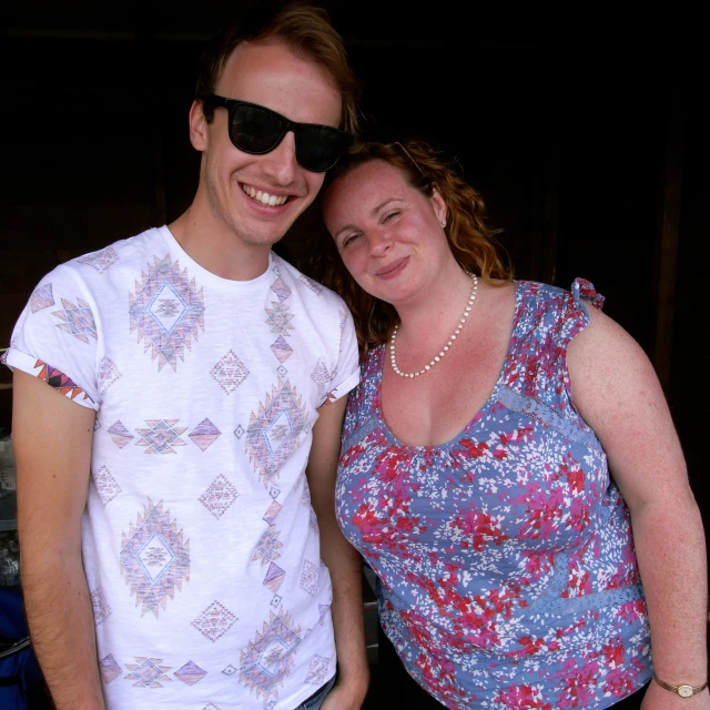 a man and woman smiling for the camera