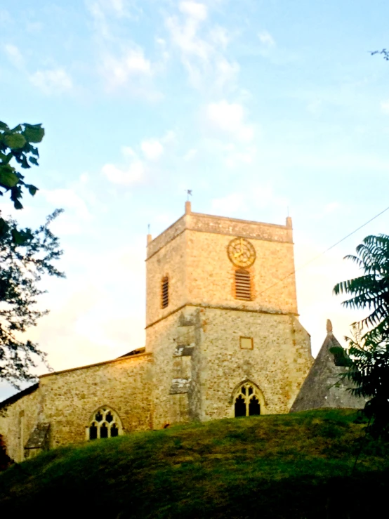 a large tall stone church sitting on top of a hillside