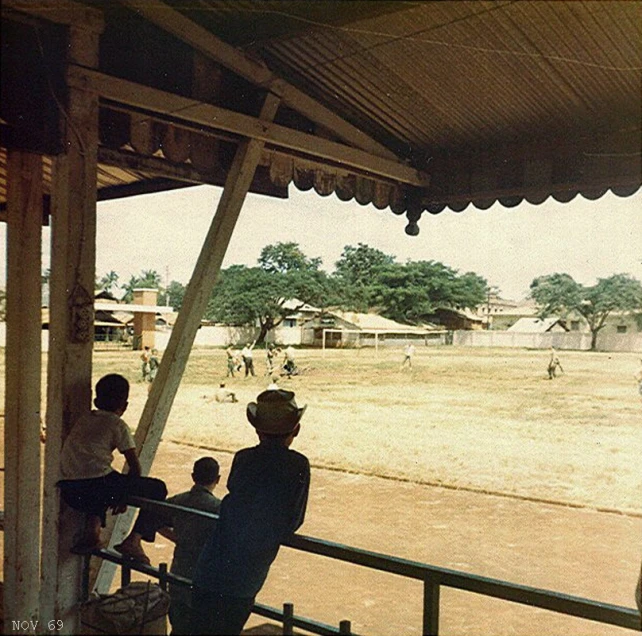 a group of men standing on top of a wooden deck