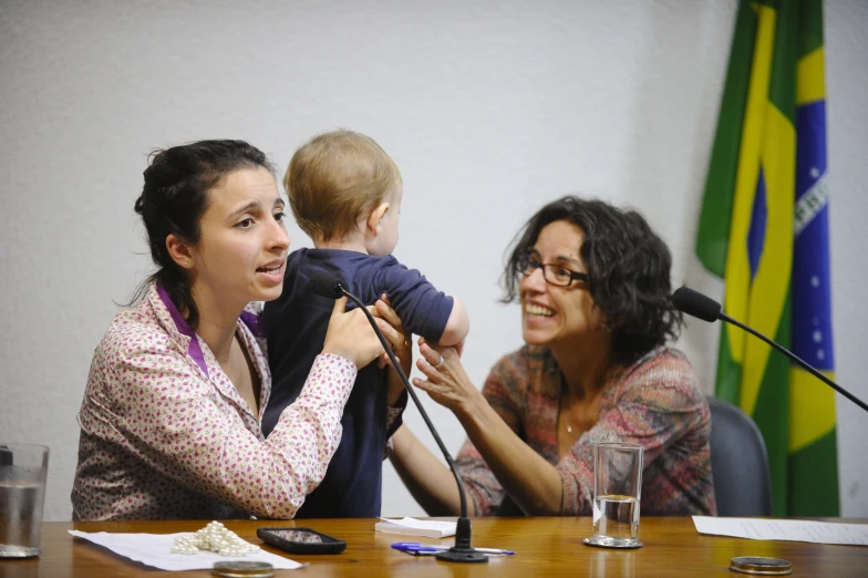 a woman and a child sitting at a table