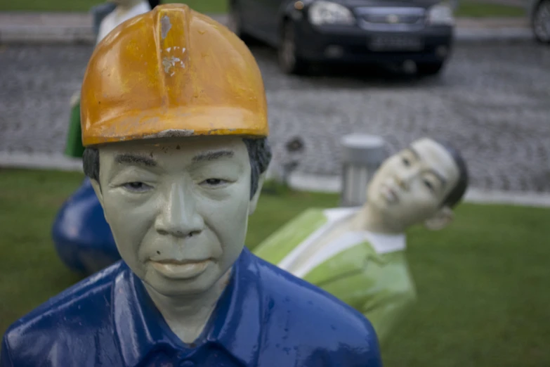 a statue wearing a hard hat and blue shirt