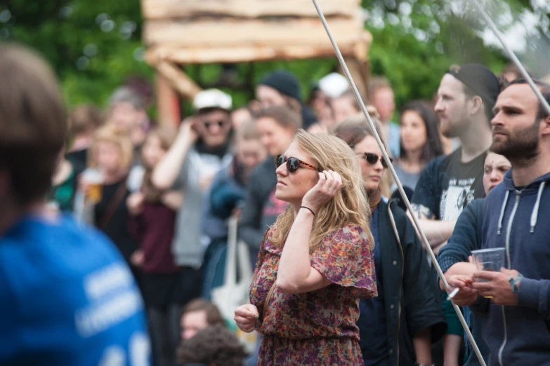 woman on her cellphone standing in front of a group of people