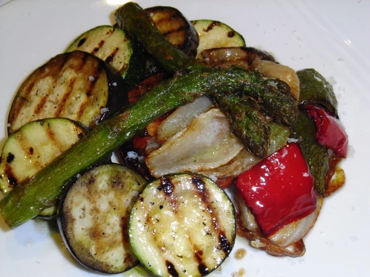 a white plate topped with vegetables and sliced up