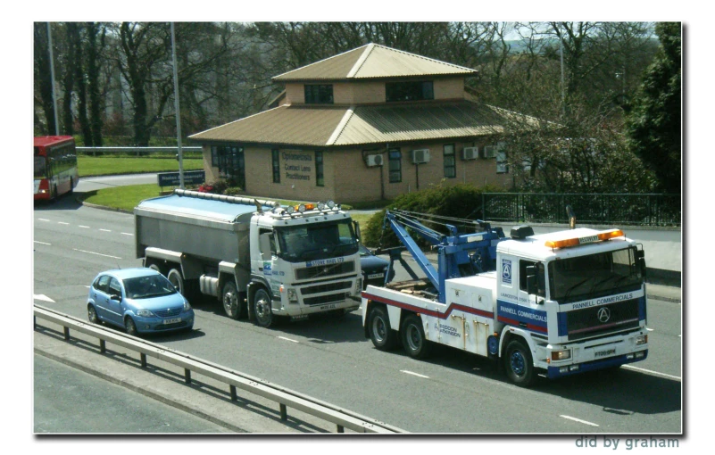 tow truck on the street towing a semi