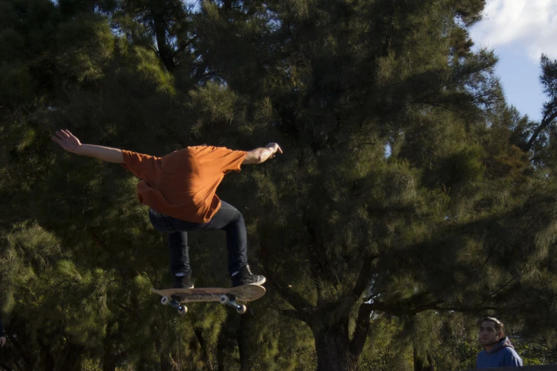 a man flying through the air while riding a skateboard