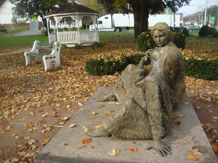 there is a statue of a woman with an umbrella on it