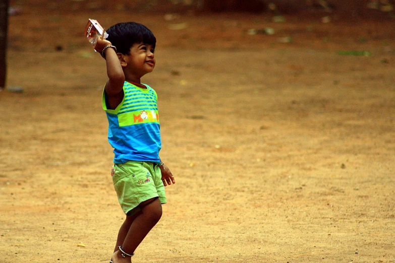 a little boy tossing a ball to another child