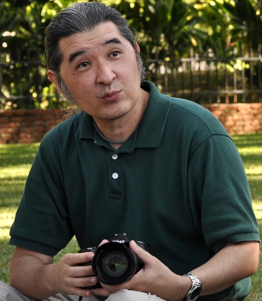 a person is sitting on the ground with a camera