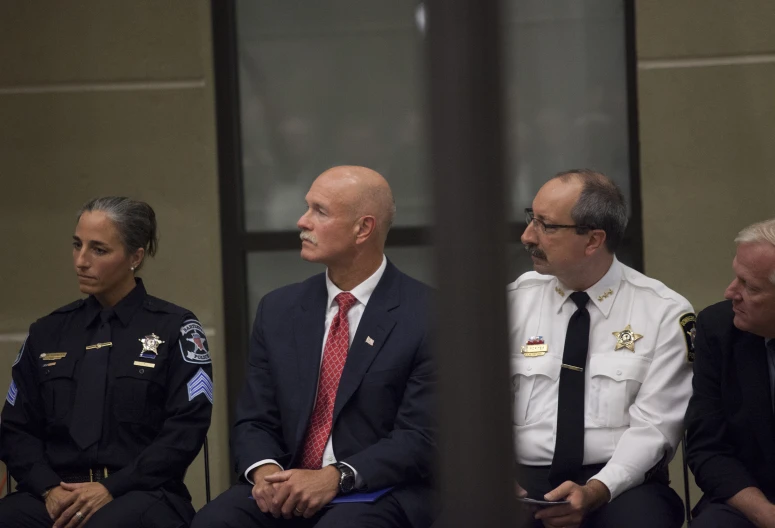 three police officers sitting next to one another