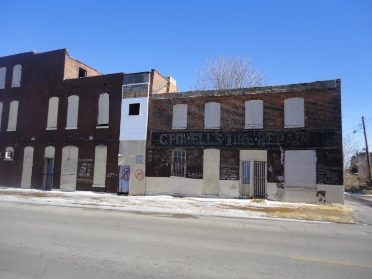 an old dilapidated building with a large sign