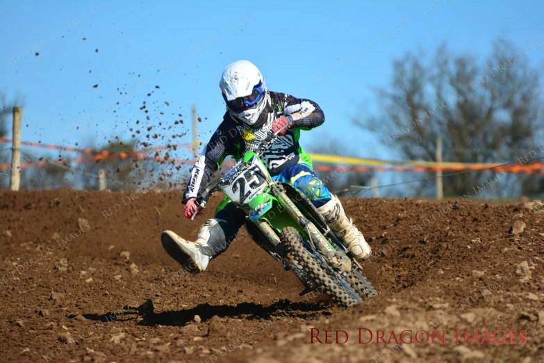 man racing bike on dirt road on sunny day