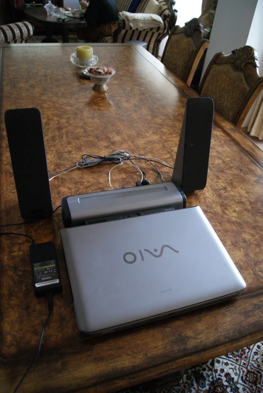 the table has an mp3 player connected to its laptop on it