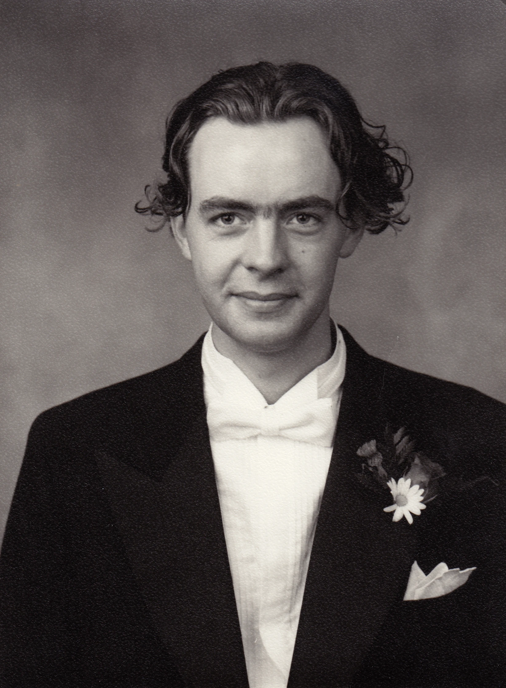 black and white pograph of a man in a tuxedo