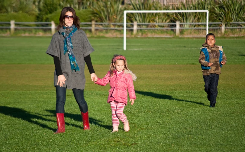 a mother with two children in a park