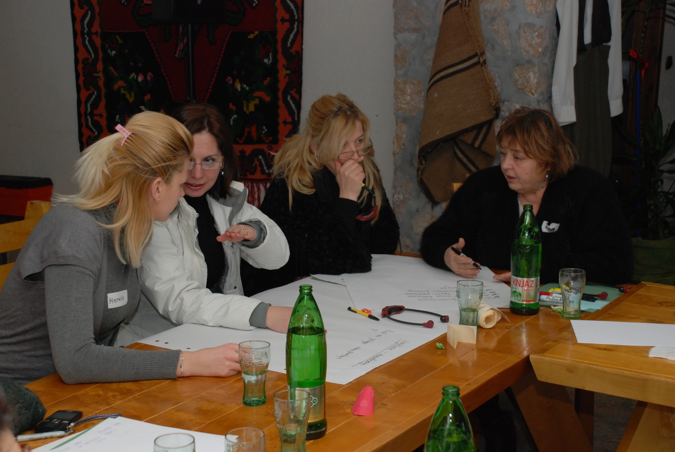 the four girls are sitting at the table together