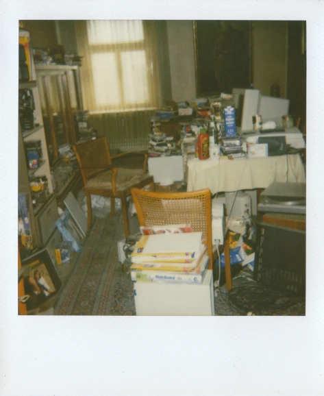 a messy room full of books and household items