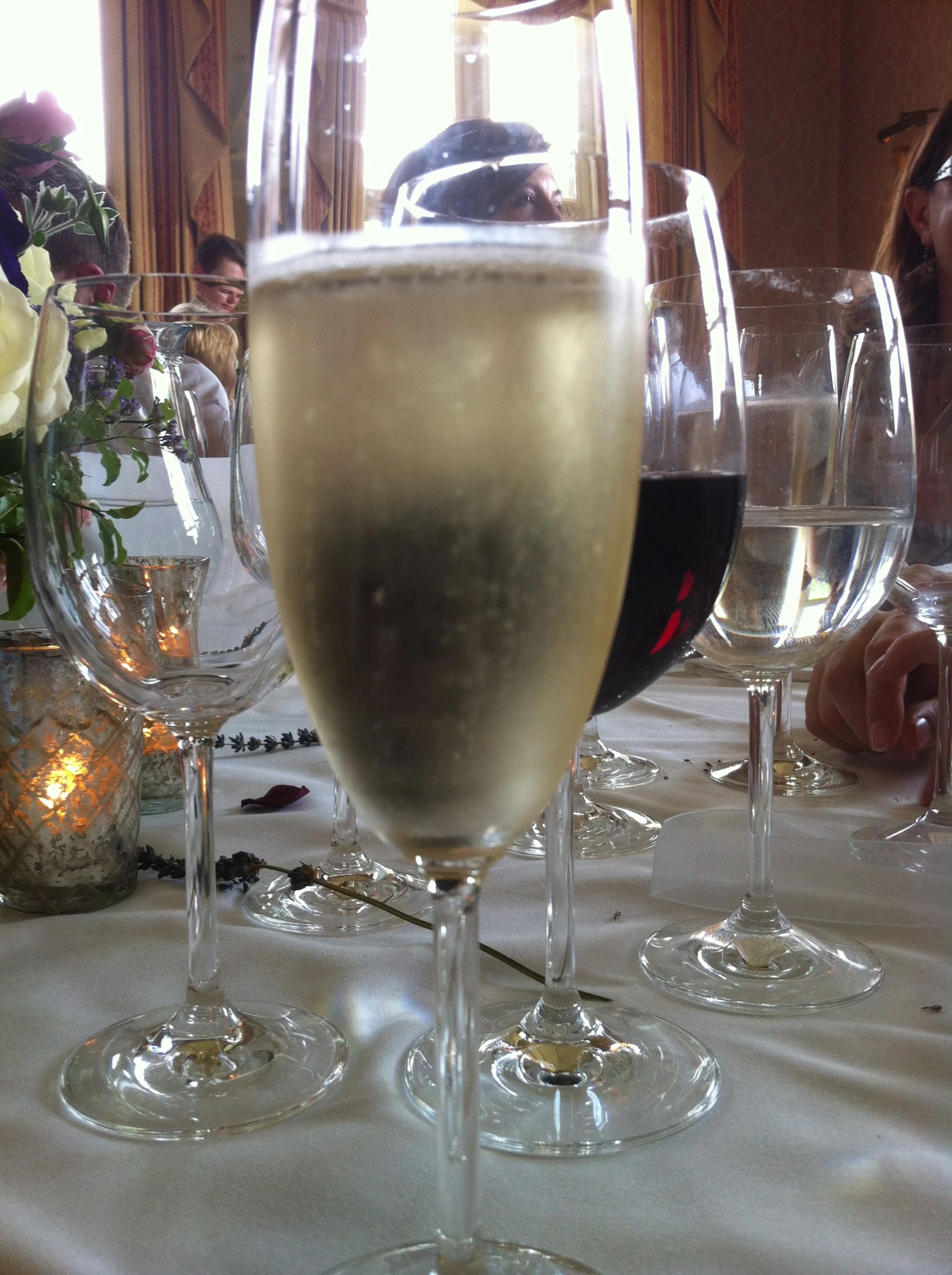 three wine glasses sit on the table for dinner guests