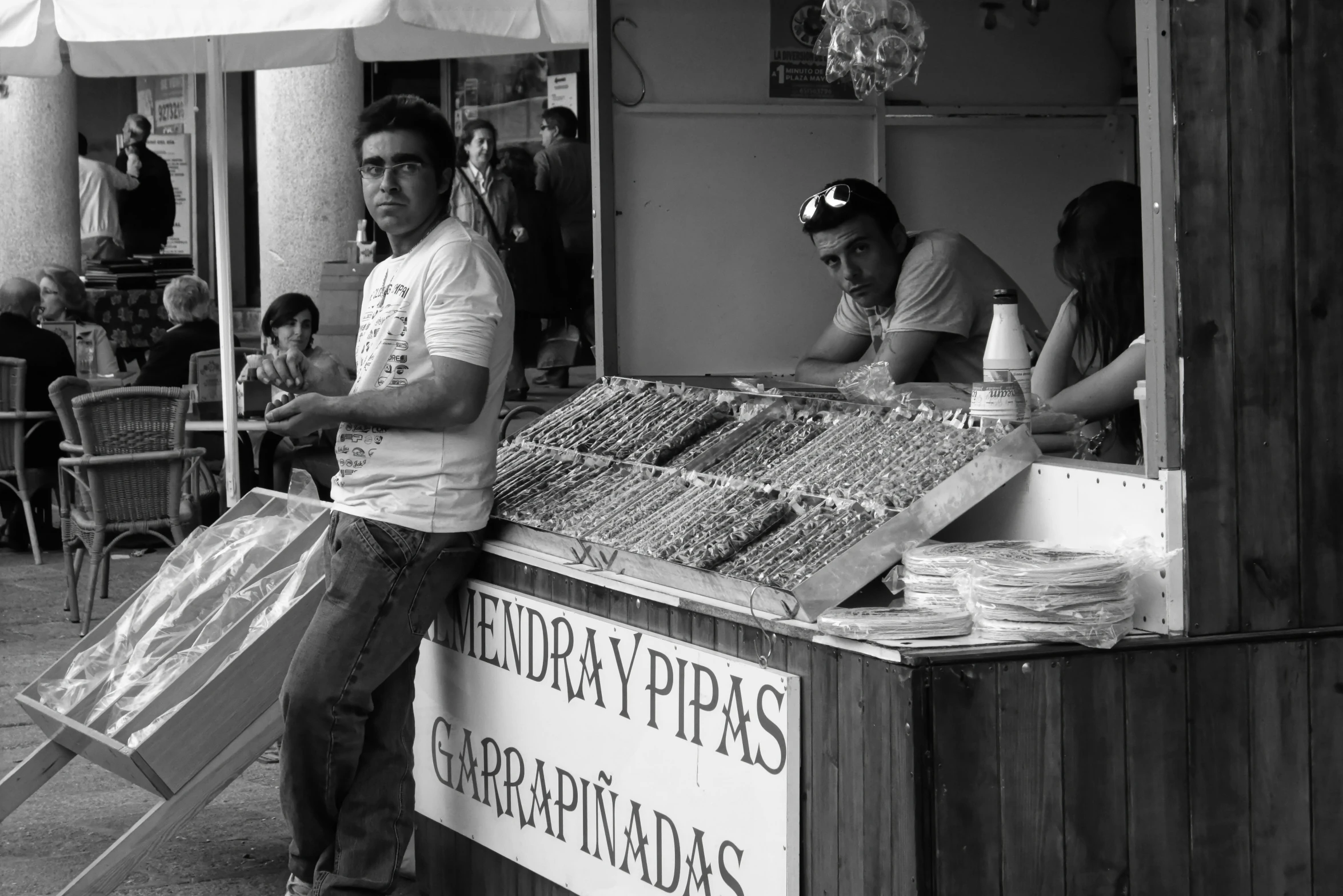 a man standing at a food cart selling condiments